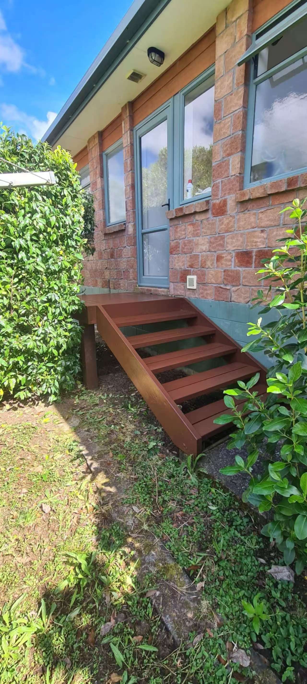 Outdoor timber steps after cleaning and staining with richer timber colour