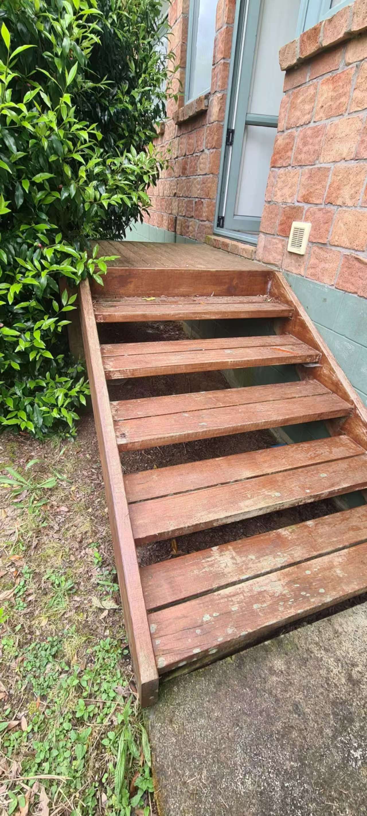 Outdoor timber steps before cleaning and staining, with weathered timber