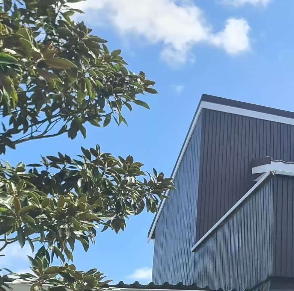 Exterior repaint after, with neat brown boards and white trims